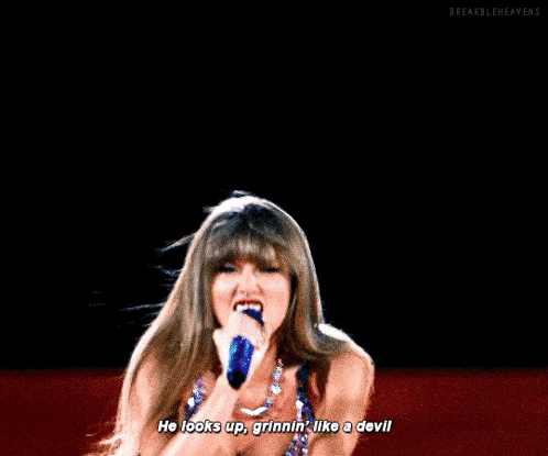 a woman in a sequined dress is singing into a microphone and says he looks up grinnin like a devil .