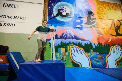 a man is doing a trick in front of a sign that says circus