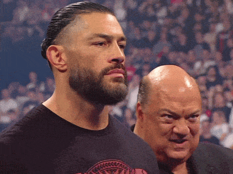 a man with a beard stands next to another man