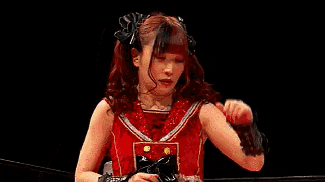a woman with red hair is wearing a red dress and holding a bottle of coke .