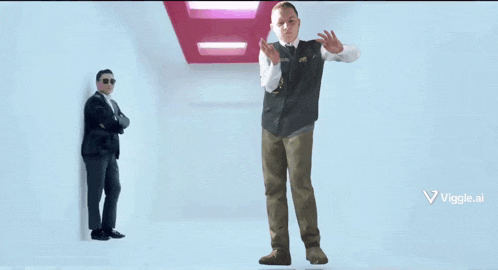 a man in a vest that says ' vigile ' on it stands next to another man