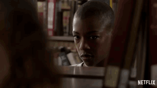 a netflix ad shows a woman behind a shelf of books and says what