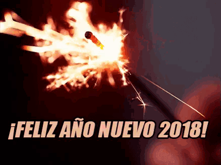 a sparkler is lit up with the words feliz ano nuevo 2018 in the background