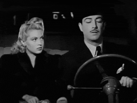 a black and white photo of a man and a woman looking at each other