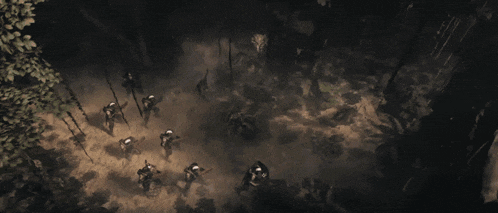 a group of people are standing in a dark room with smoke coming out of the ceiling .
