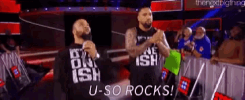 two men are standing on a stage and one of them is wearing a shirt that says u-so rocks !
