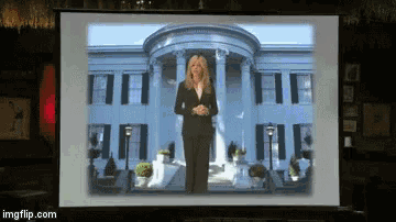 a woman stands in front of a white house on a screen