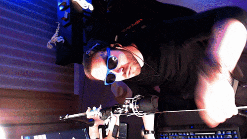 a man wearing sunglasses and a black shirt that says ' glock ' on it