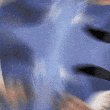 a blurry picture of a person 's face with a blue shirt on