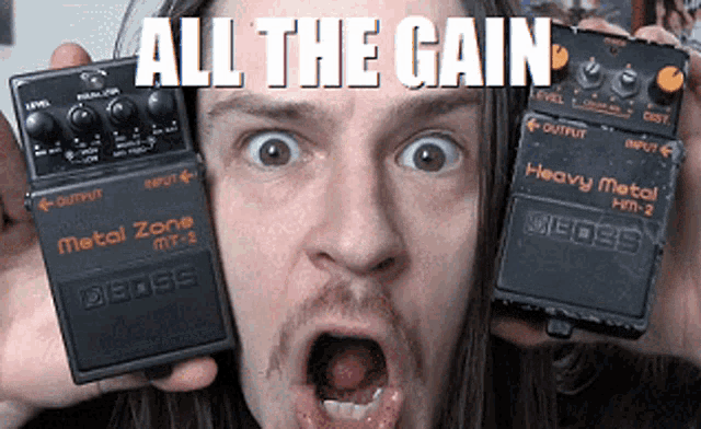 a man holding a metal zone and heavy metal effects pedal