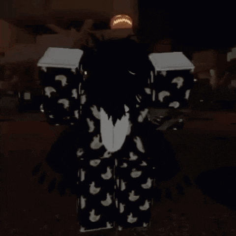 a person is standing in a dark room wearing a black and white shirt with a chicken pattern .