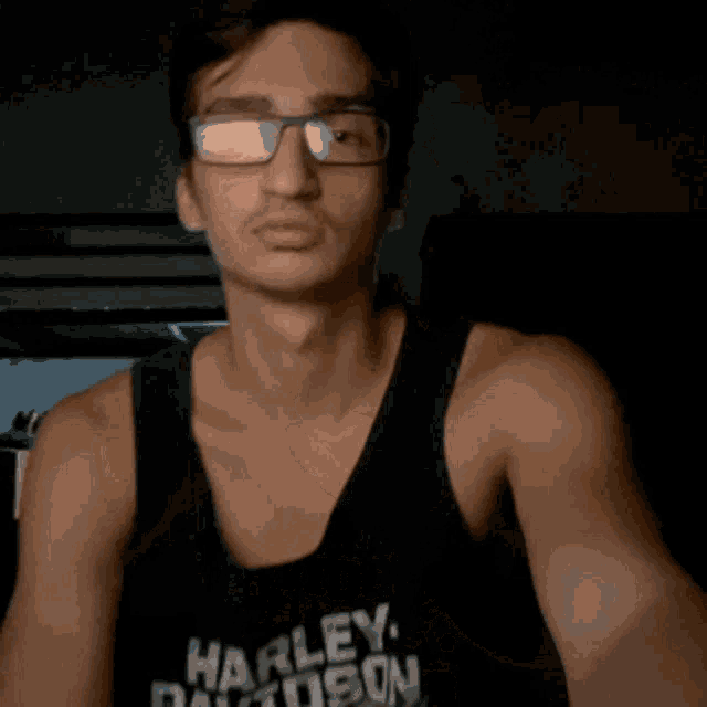 a man wearing a harley davidson tank top