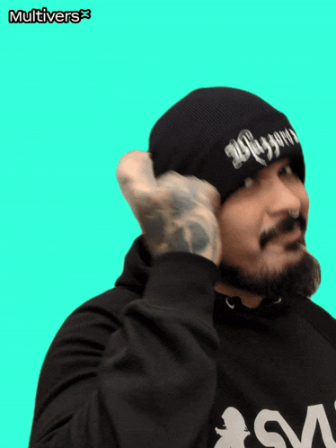 a man wearing a beanie and a hoodie with the word multivers on the bottom