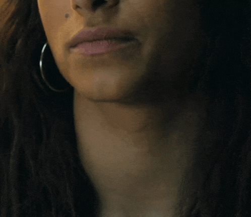 a close up of a woman 's mouth and neck