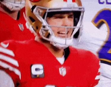 a close up of a football player wearing a helmet with the letter c on his jersey