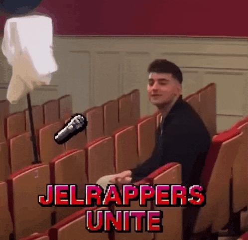 a man sitting in an auditorium with the words jelrappers unite