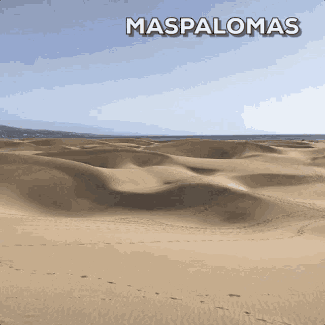 a picture of a desert with the words maspalomas on the top
