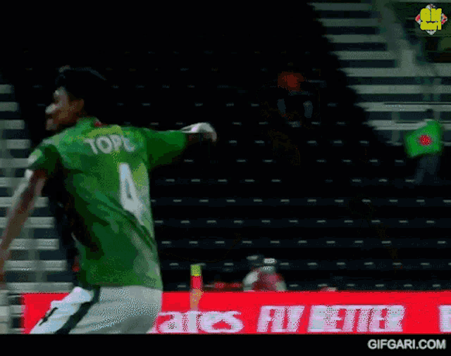 a man in a green jersey with the number 2 on it