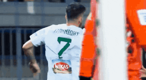 a soccer player with the number 7 on his jersey is running