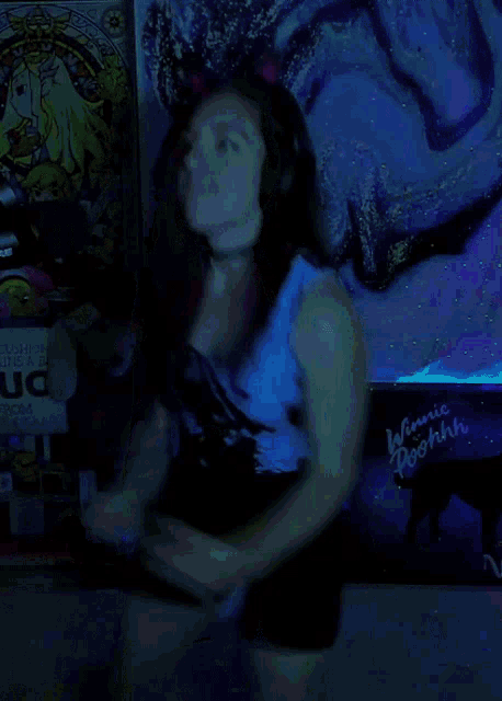 a woman dancing in front of a poster that says uo