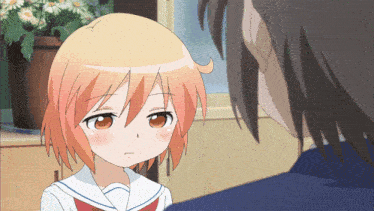 a girl with orange hair is looking at a boy with black hair