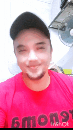 a man wearing a red shirt that says 6mon9 on it