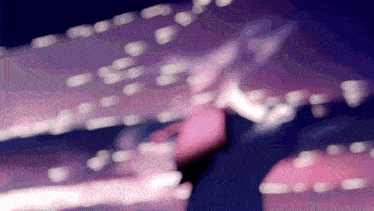 a blurry picture of a person 's face and a purple background with a few white dots