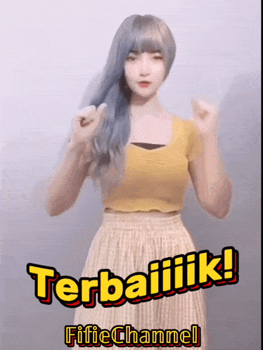 a woman in a yellow top and striped skirt with the words terbaiiik fifichannel