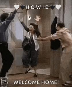 a group of people are dancing in front of a door with hearts on it .