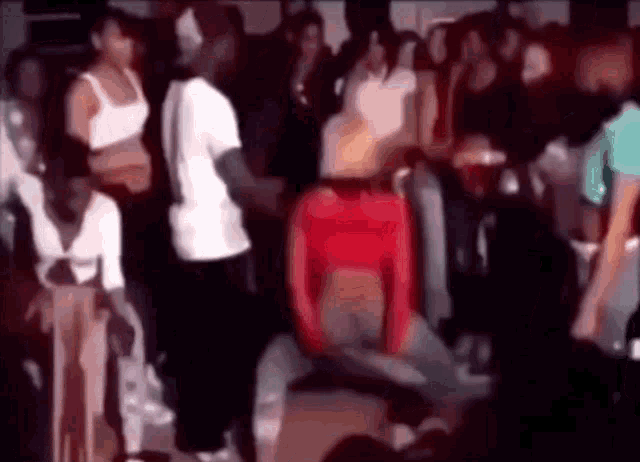 a group of people are dancing at a party in a club .