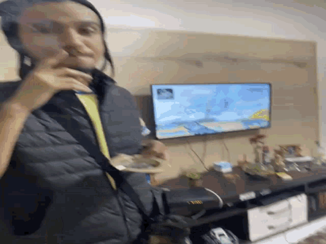a man is sitting in front of a television with a map on it