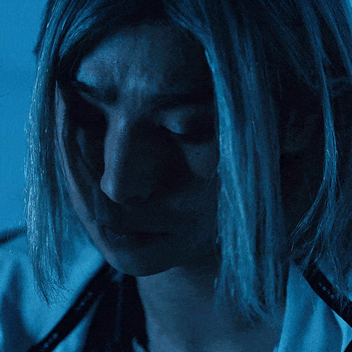 a close up of a woman 's face in the dark