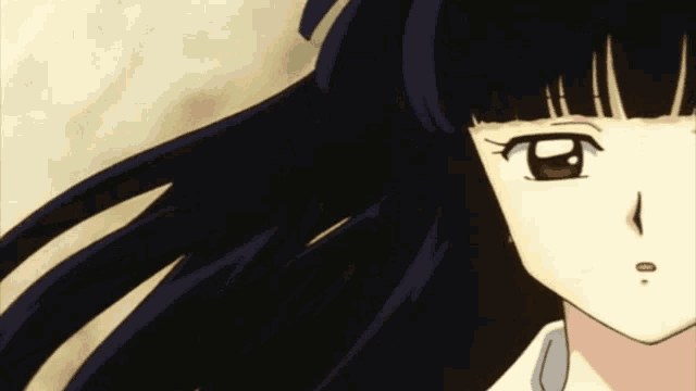 a close up of a girl 's face with black hair