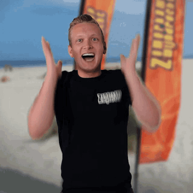 a man wearing a black shirt that says zandzandz