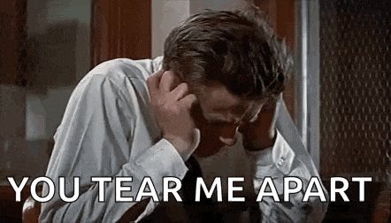 a man in a white shirt and tie is covering his ears with his hands while saying `` you tear me apart '' .