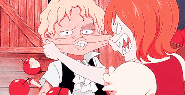 a girl is holding a boy 's face with her hand