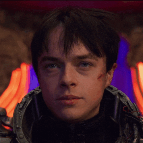 a close up of a man 's face with a helmet on his head