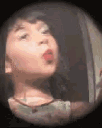 a little girl blowing a kiss with red lipstick on her lips