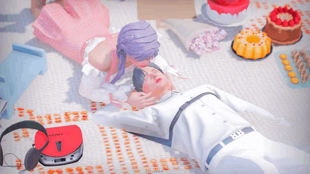 a woman kissing a man laying on a blanket with a sony cd player