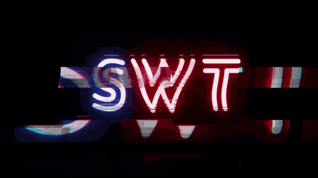 a neon sign that says swt is lit up