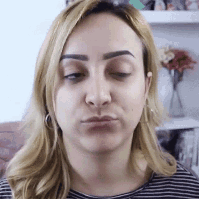 a close up of a woman 's face with her eyes closed