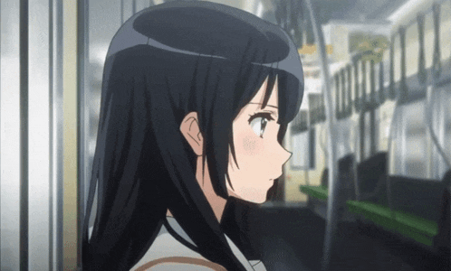 a girl with long black hair is standing in a train