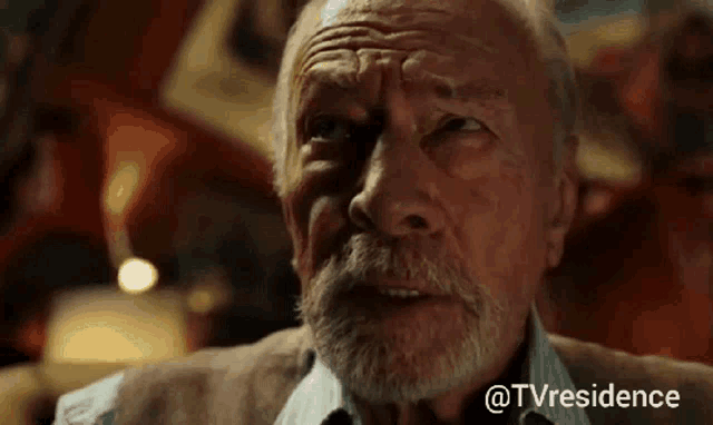 an older man with a beard is sitting in a dark room with a caption that says " @tvresidence "