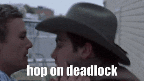 a man in a cowboy hat is kissing another man with the words hop on deadlock written below him