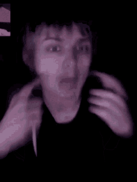 a blurry picture of a person 's face and neck