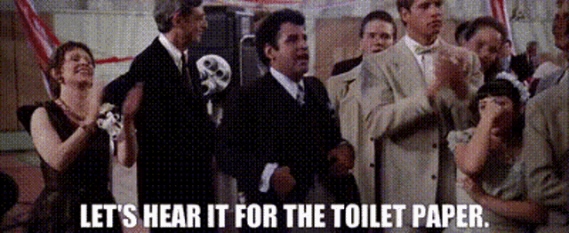 a group of people standing in a room with the words let 's hear it for the toilet paper below them