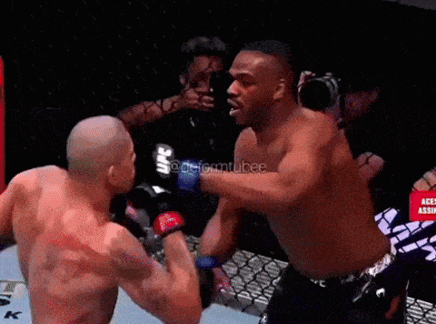 two men are fighting in a boxing ring and one of them is wearing a ufc glove