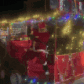 a close up of a red bus with christmas lights on it