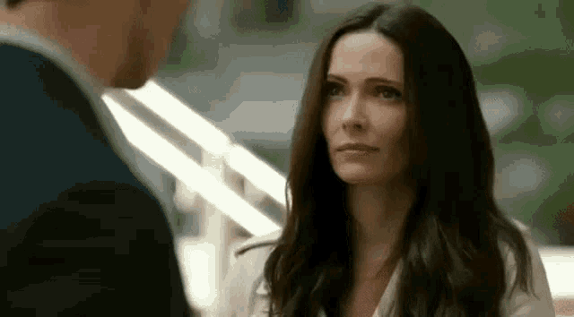 a man and a woman are looking at each other .