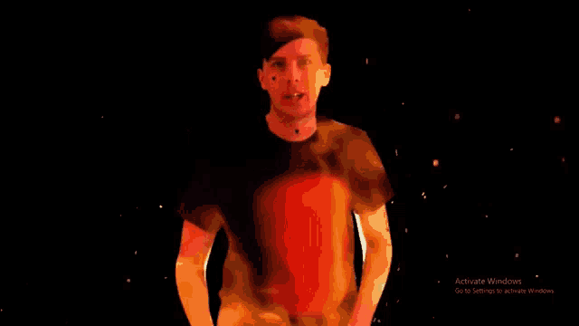 a man giving a thumbs up in front of a black screen that says activate windows